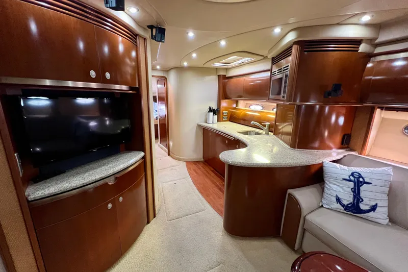Slide: The Image of Luxurious interior of 2005 Sea Ray 500 Sundancer yacht with modern kitchen and entertainment area. - 16
