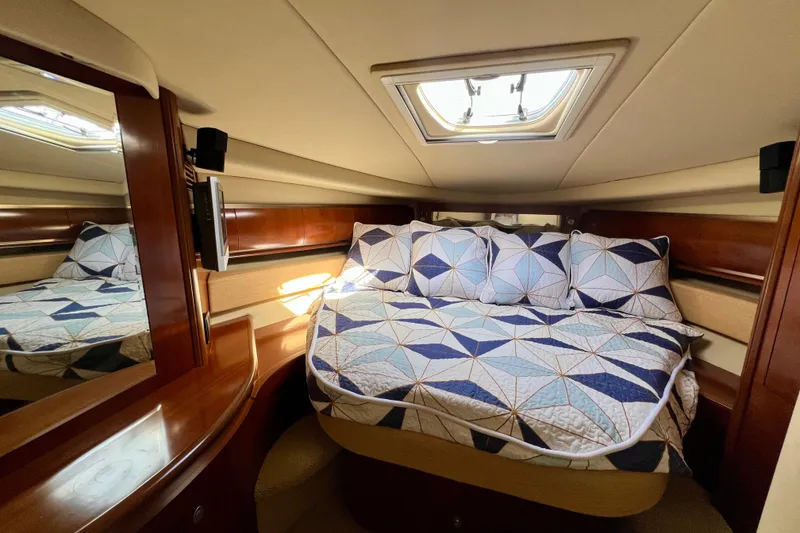 Slide: The Image of Luxurious cabin interior of 2005 Sea Ray 500 Sundancer yacht with quilted bedding. - 18