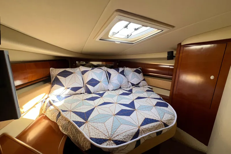 Slide: The Image of Luxurious cabin interior of 2005 Sea Ray 500 Sundancer with geometric bedding. - 19