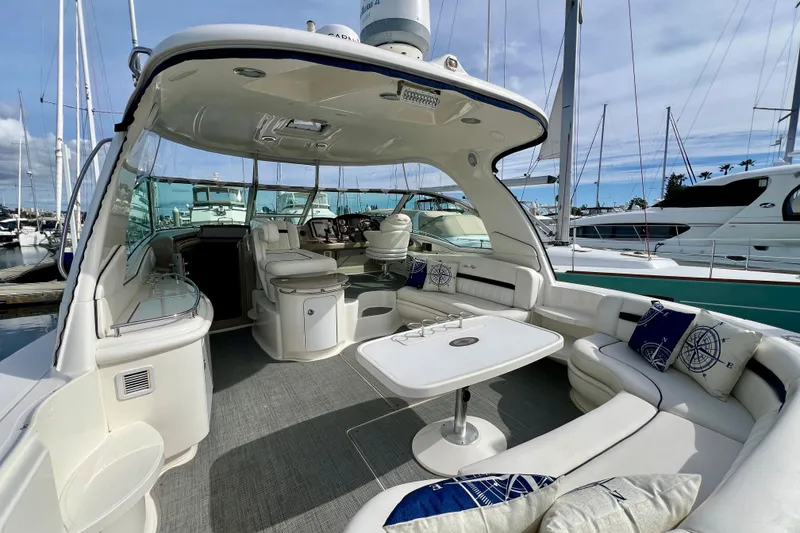 Slide: The Image of 2005 Sea Ray 500 Sundancer yacht interior with seating and table, docked at marina. - 3