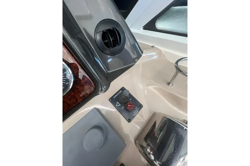 Slide: The Image of Control panel of a 2005 Sea Ray 500 Sundancer boat, featuring a thruster switch. - 31