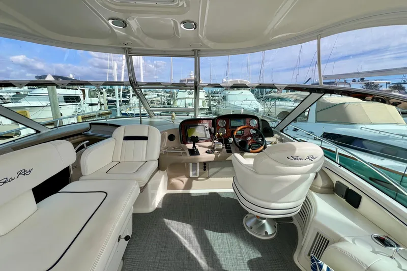 Slide: The Image of 2005 Sea Ray 500 Sundancer yacht cockpit with luxurious seating and modern navigation controls. - 7