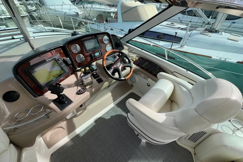 Slide: The Image of Luxurious helm of 2005 Sea Ray 500 Sundancer with advanced navigation systems. - 9