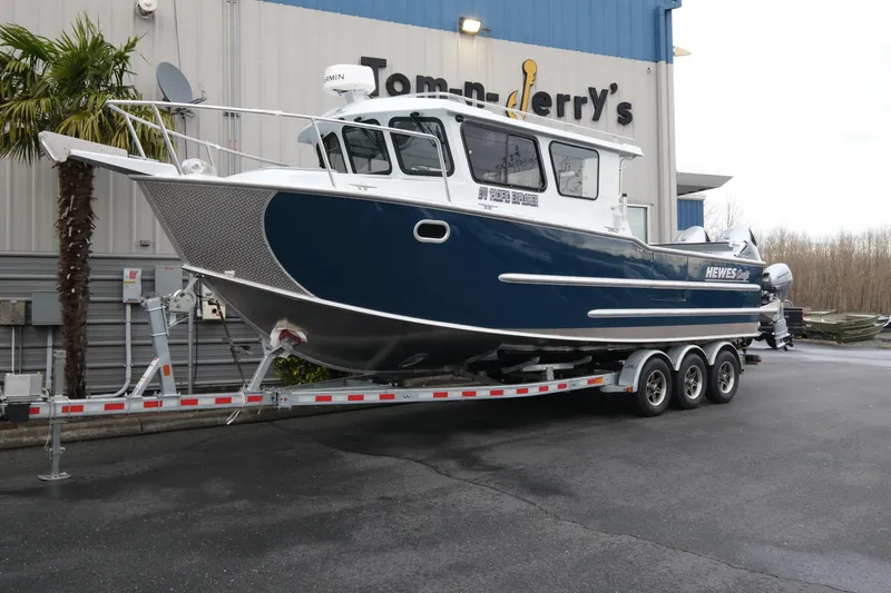 The Image of 2026 Hewescraft 270 Pacific Explorer boat on trailer outside dealership. - 1
