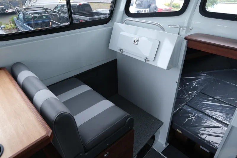 Slide: The Image of Interior of 2026 Hewescraft 270 Pacific Explorer with seating and storage area. - 12