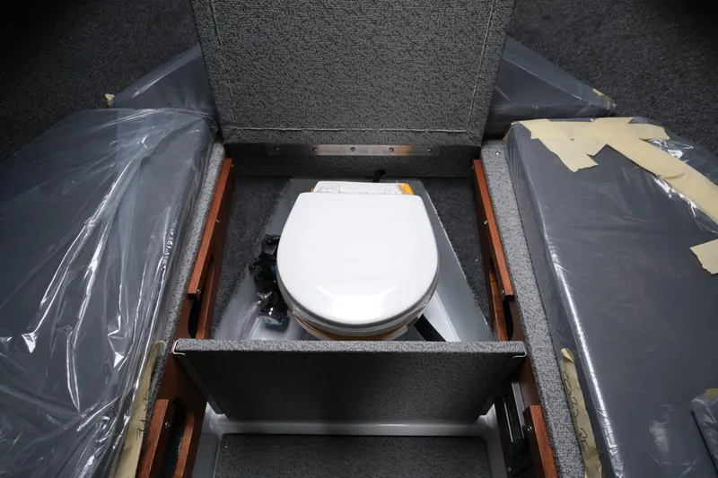 Slide: The Image of 2026 Hewescraft 270 Pacific Explorer interior with compact marine toilet. - 14