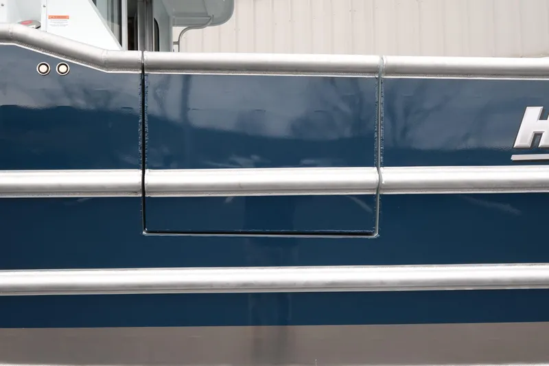 Slide: The Image of 2026 Hewescraft 270 Pacific Explorer, blue hull detail with metallic accents. - 16