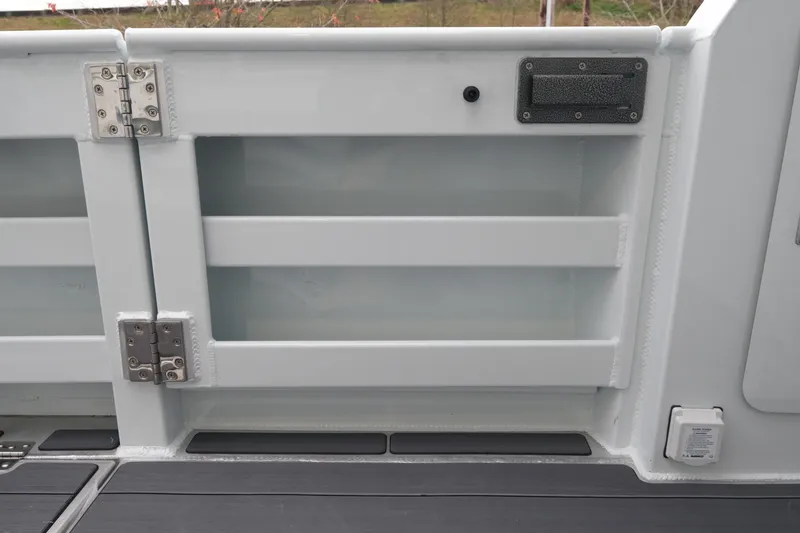 Slide: The Image of 2026 Hewescraft 270 Pacific Explorer boat interior detail with storage compartment and hinges. - 17