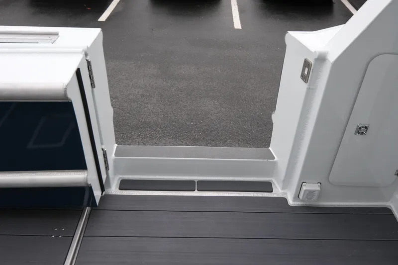 Slide: The Image of 2026 Hewescraft 270 Pacific Explorer boat deck with open door, showcasing sleek design. - 18