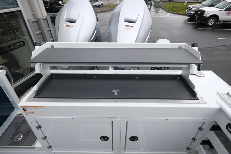 Slide: The Image of 2026 Hewescraft 270 Pacific Explorer boat with dual outboard motors, featuring a spacious deck area. - 23