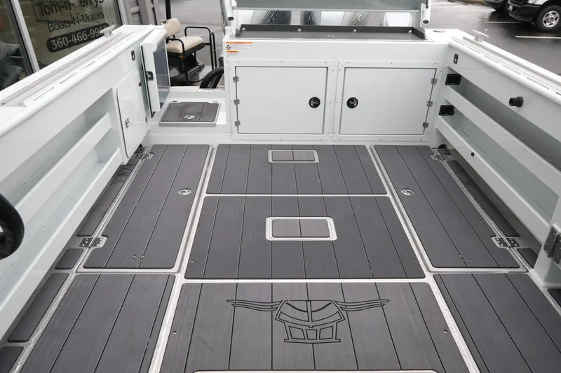 Slide: The Image of 2026 Hewescraft 270 Pacific Explorer boat deck with storage compartments and sleek design. - 5