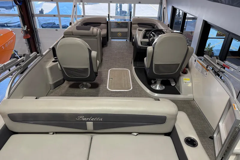 Slide: The Image of 2024 Barletta Cabrio C22UC pontoon boat interior with gray seating and modern design. - 12