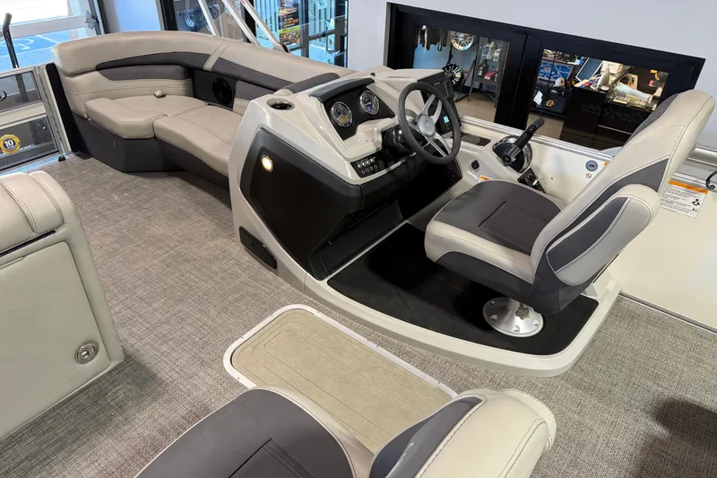 Slide: The Image of 2024 Barletta Cabrio C22UC pontoon boat with Mercury engine, displayed indoors. - 14