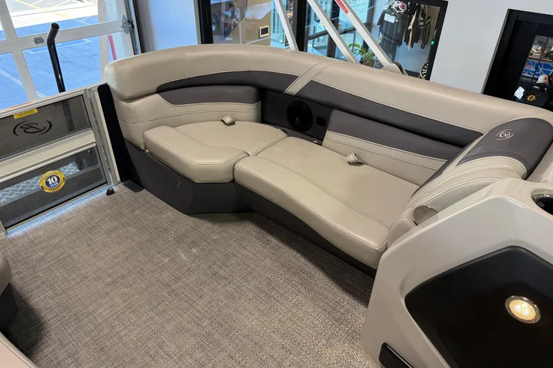 Slide: The Image of 2024 Barletta Cabrio C22UC boat interior with convertible seating and cup holders. - 18