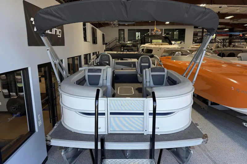 Slide: The Image of 2024 Barletta Cabrio C22UC pontoon boat interior with plush seating and modern dashboard. - 20