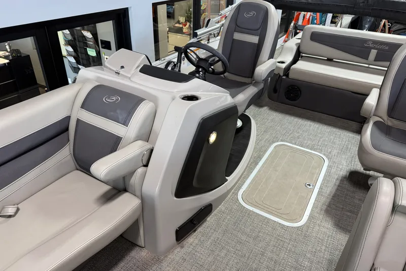 Slide: The Image of 2024 Barletta Cabrio C22UC boat cockpit with steering wheel and control panel. - 23