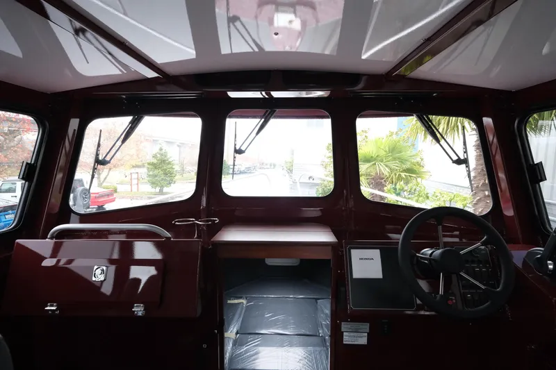 Slide: The Image of Interior view of 2026 Hewescraft 240 Pacific Cruiser boat cockpit with steering wheel. - 16