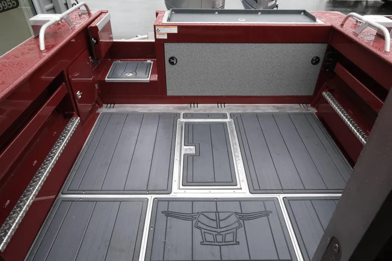 Slide: The Image of Interior of 2026 Hewescraft 240 Pacific Cruiser boat, featuring sleek flooring and storage compartments. - 8