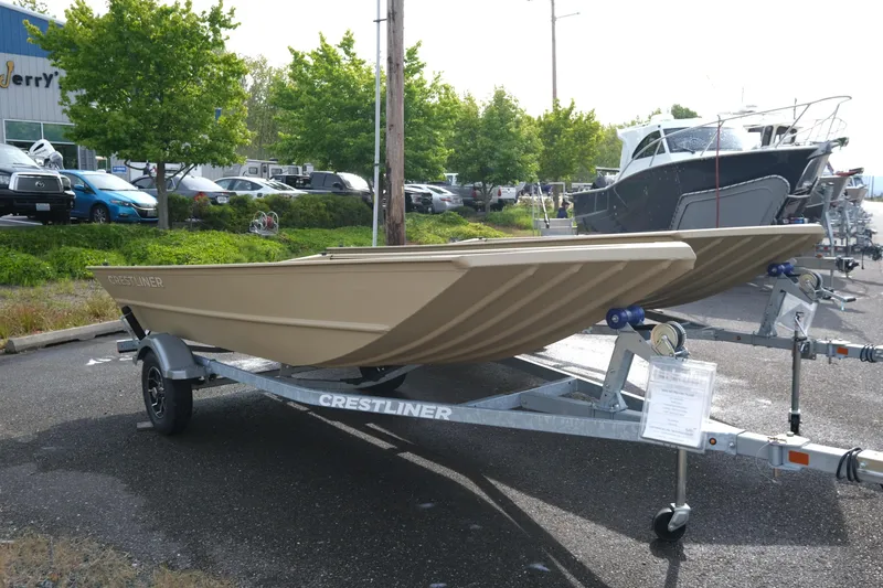 The Image of 2025 Crestliner 1660 Retriever boat on trailer in outdoor dealership lot. - 0
