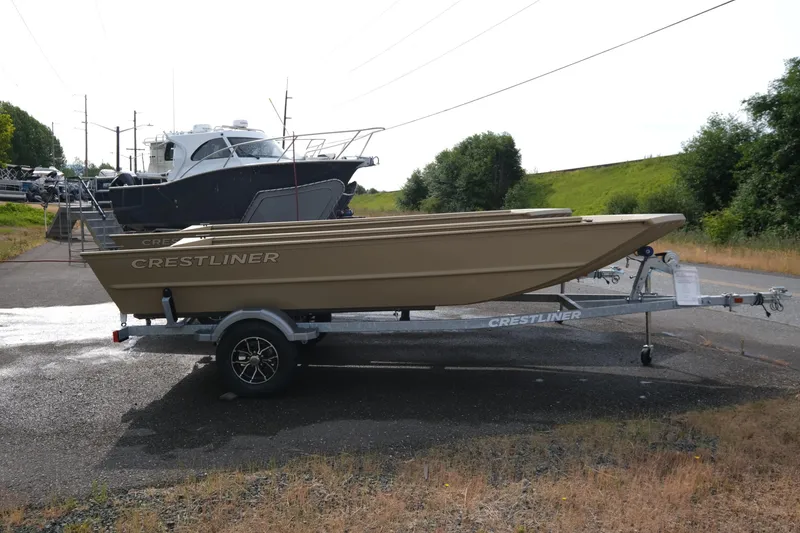 Slide: The Image of 2025 Crestliner 1660 Retriever boat on trailer, parked outdoors. - 2