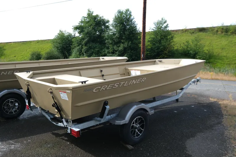 Slide: The Image of 2025 Crestliner 1660 Retriever boat on trailer, parked outdoors. - 3