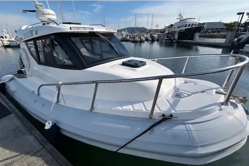 Slide: The Image of 2024 Flexboat 680 Explorer docked at marina, featuring sleek design and advanced navigation equipment. - 11
