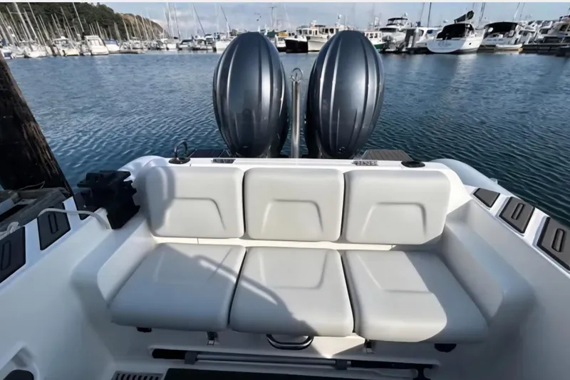 Slide: The Image of 2024 Flexboat 680 Explorer with dual engines, docked in a marina. - 16