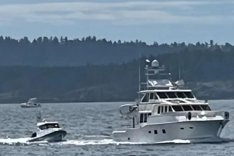 Slide: The Image of 2024 Flexboat 680 Explorer cruising alongside a large yacht on a scenic waterway. - 17