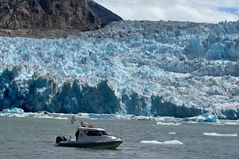Slide: The Image of 2024 Flexboat 680 Explorer near icy glacier backdrop, serene arctic waters. - 19