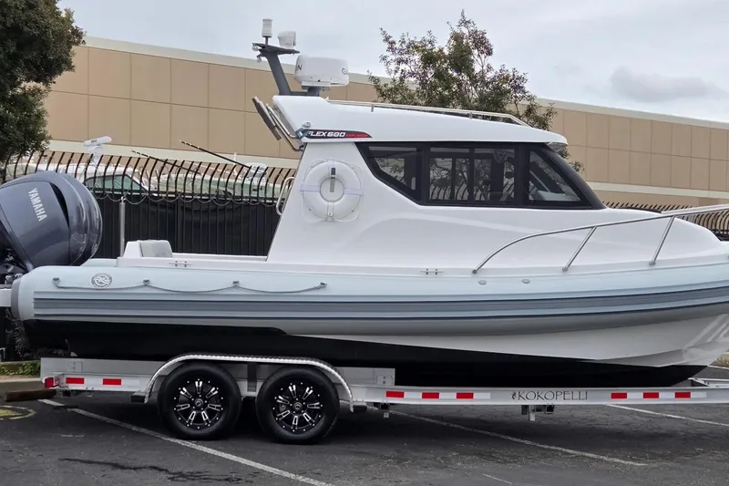 Slide: The Image of 2024 Flexboat 680 Explorer on trailer, featuring Yamaha outboard motor. - 21