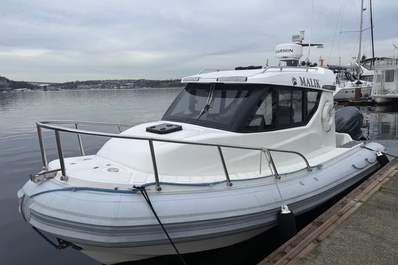 Slide: The Image of 2024 Flexboat 680 Explorer docked, featuring sleek design and advanced navigation equipment. - 23