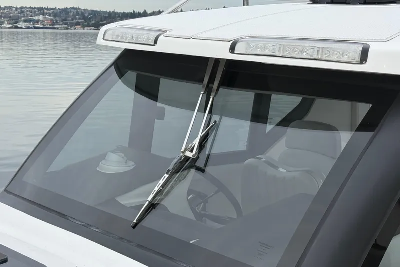 Slide: The Image of 2024 Flexboat 680 Explorer windshield with wiper, overlooking calm waters. - 24
