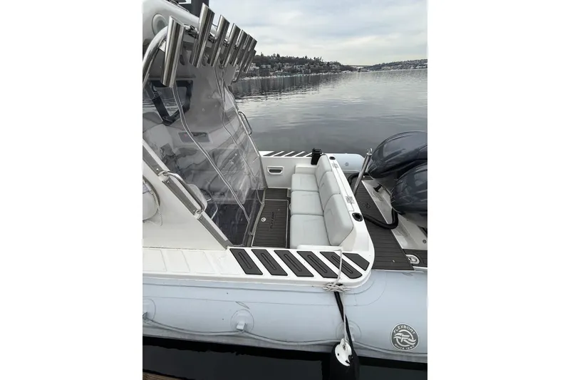 Slide: The Image of 2024 Flexboat 680 Explorer with sleek seating and dual engines on calm water. - 27