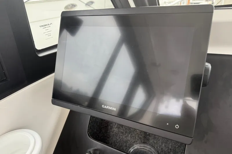 Slide: The Image of Garmin display on 2024 Flexboat 680 Explorer dashboard, showcasing modern navigation technology. - 29