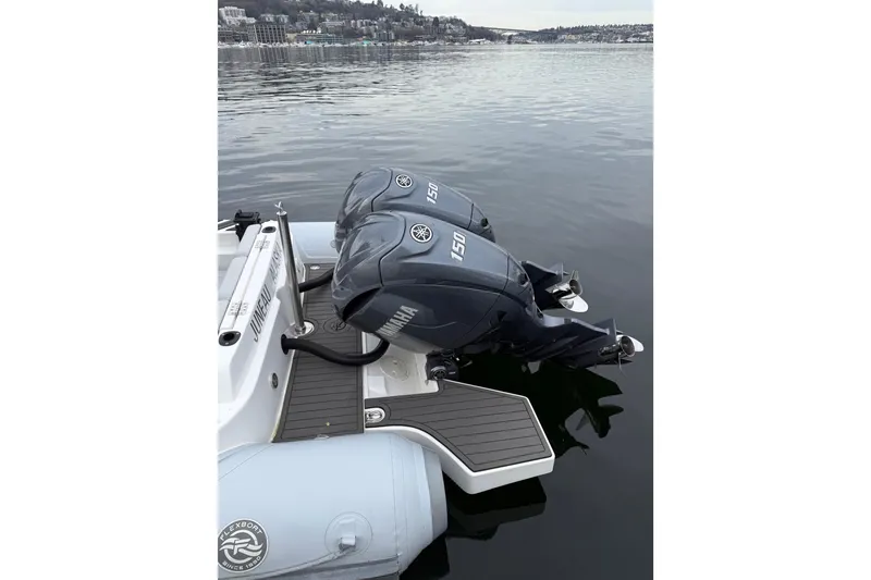 Slide: The Image of 2024 Flexboat 680 Explorer with dual Yamaha 150 engines on calm water. - 31