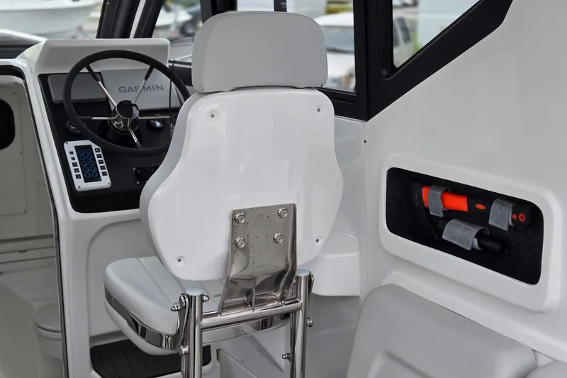 Slide: The Image of Interior of 2024 Flexboat 680 Explorer, featuring steering wheel and storage compartment. - 4