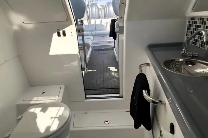 Slide: The Image of Interior of 2024 Flexboat 680 Explorer, featuring a compact bathroom and sleek design. - 5