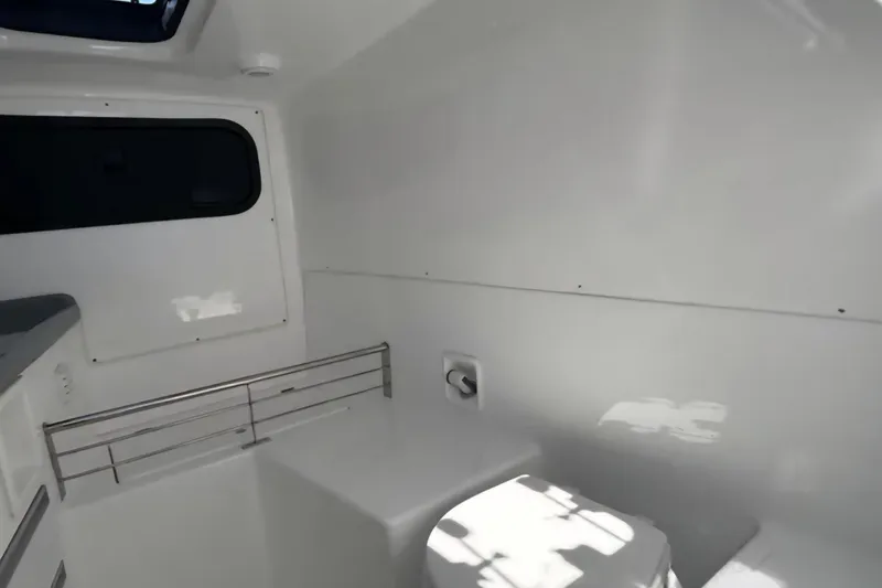 Slide: The Image of 2024 Flexboat 680 Explorer interior cabin with sleek white design and window. - 8