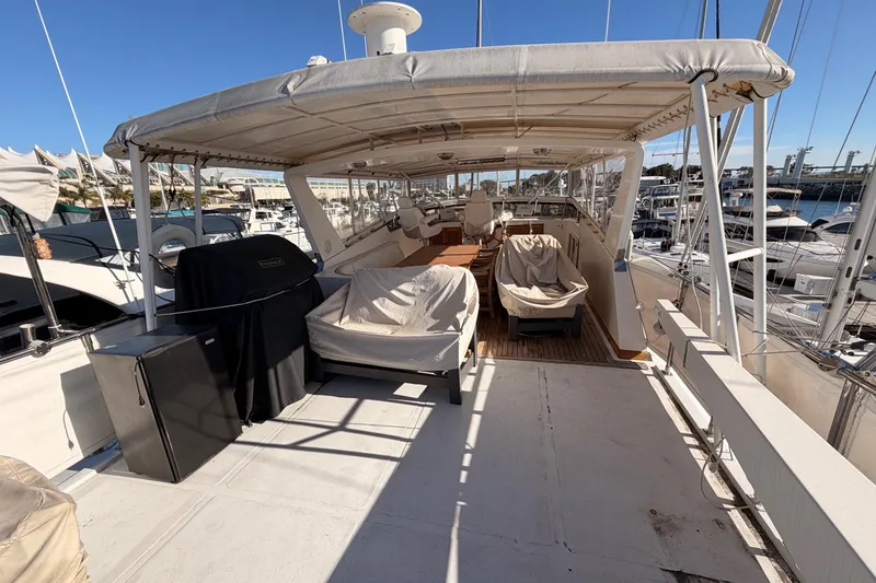 Slide: The Image of 1984 Hartman-Palmer 60 Flush Deck Motor Yacht, spacious deck with covered seating area. - 3