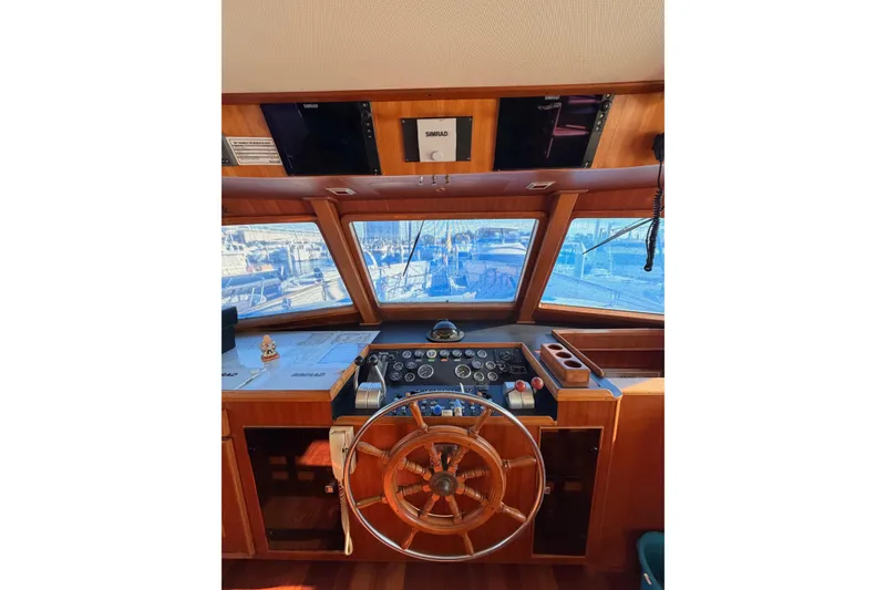Slide: The Image of Helm of 1984 Hartman-Palmer 60 Flush Deck Motor Yacht with wooden steering wheel and navigation equipment. - 5