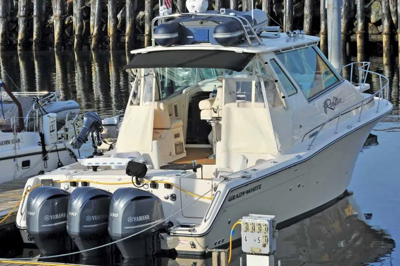 Slide: The Image of 2016 Grady-White Express 370 boat docked with triple Yamaha engines. - 3