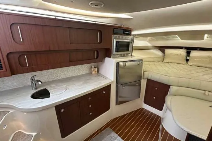 Slide: The Image of Luxurious 2016 Grady-White Express 370 cabin interior with kitchenette and cozy sleeping area. - 6