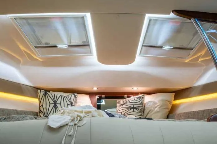 Slide: The Image of Interior cabin of 2016 Grady-White Express 370 with skylights and cozy bedding. - 9
