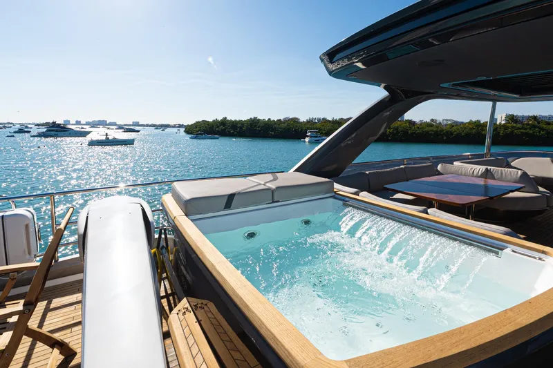 Slide: The Image of Luxurious 2022 Princess Y85 yacht with jacuzzi, overlooking a serene ocean view. - 12