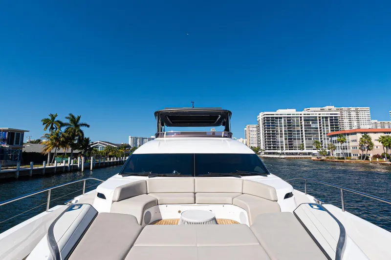 Slide: The Image of Luxurious 2022 Princess Y85 yacht cruising near waterfront cityscape under clear blue sky. - 15