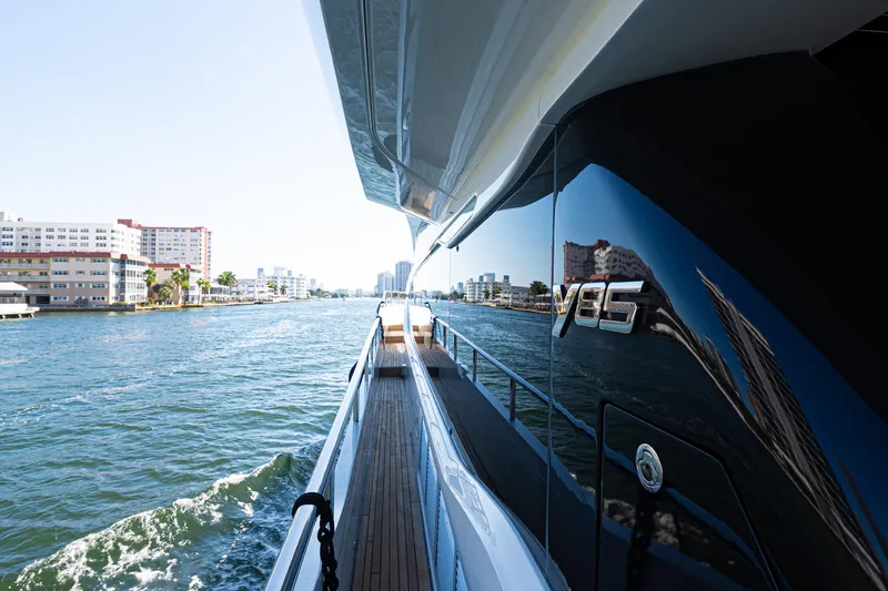 Slide: The Image of Luxurious 2022 Princess Y85 yacht cruising along a scenic waterfront. - 21