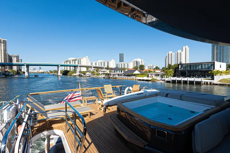 Slide: The Image of Luxurious 2022 Princess Y85 yacht with hot tub, cruising in a scenic urban waterway. - 25