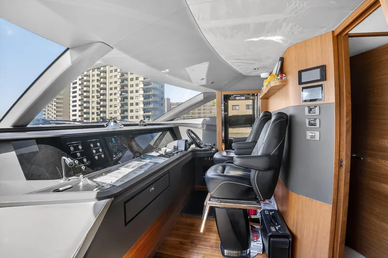Slide: The Image of Luxurious 2022 Princess Y85 yacht cockpit with modern controls and leather seating. - 40