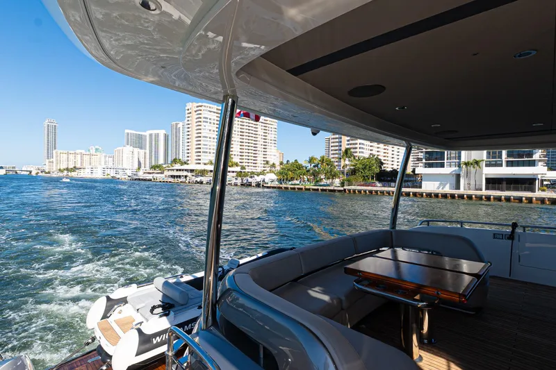Slide: The Image of Luxurious 2022 Princess Y85 yacht cruising near city waterfront, featuring elegant outdoor seating. - 42