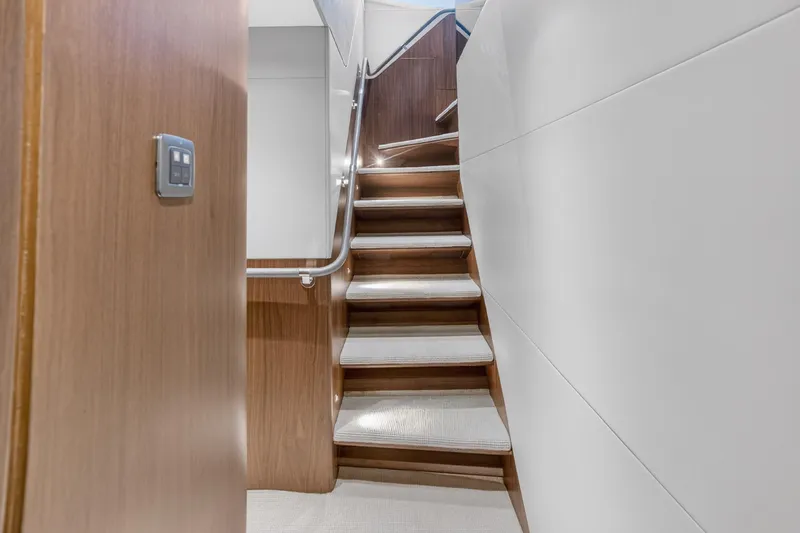 Slide: The Image of Staircase inside 2022 Princess Y85 yacht, featuring sleek wood and modern design. - 46